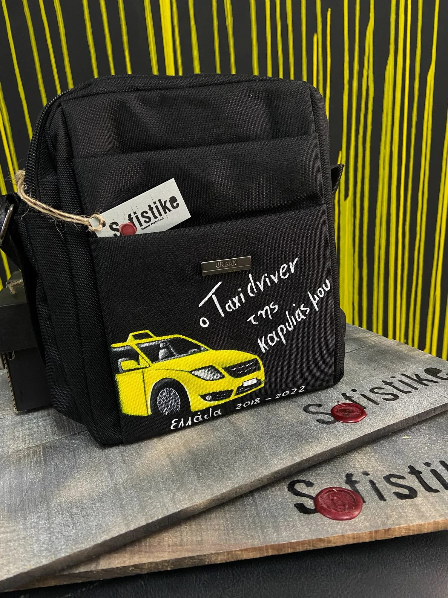 Black bag hand-painted with a yellow taxi