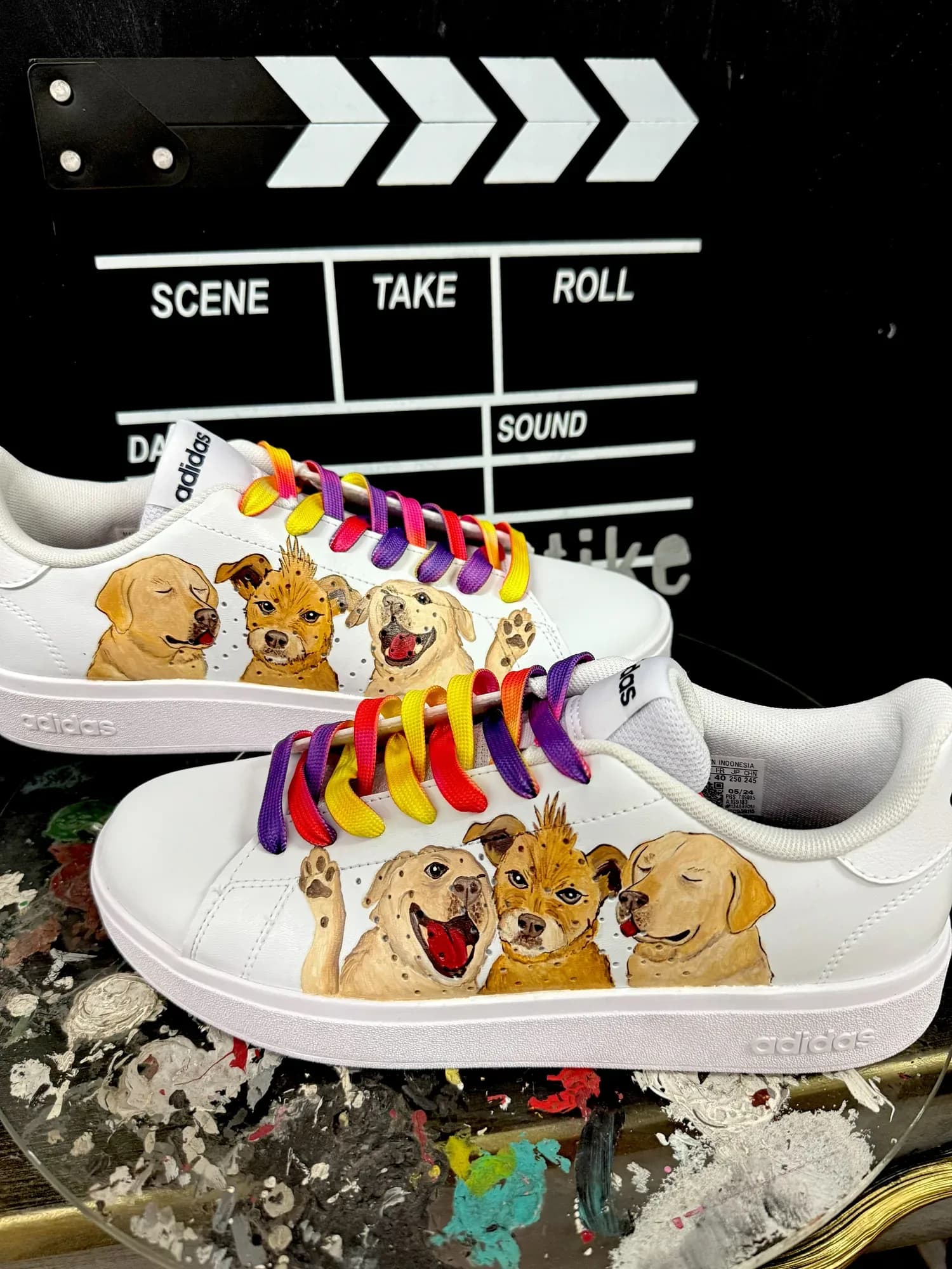 White sneakers hand-painted with puppies and rainbow laces