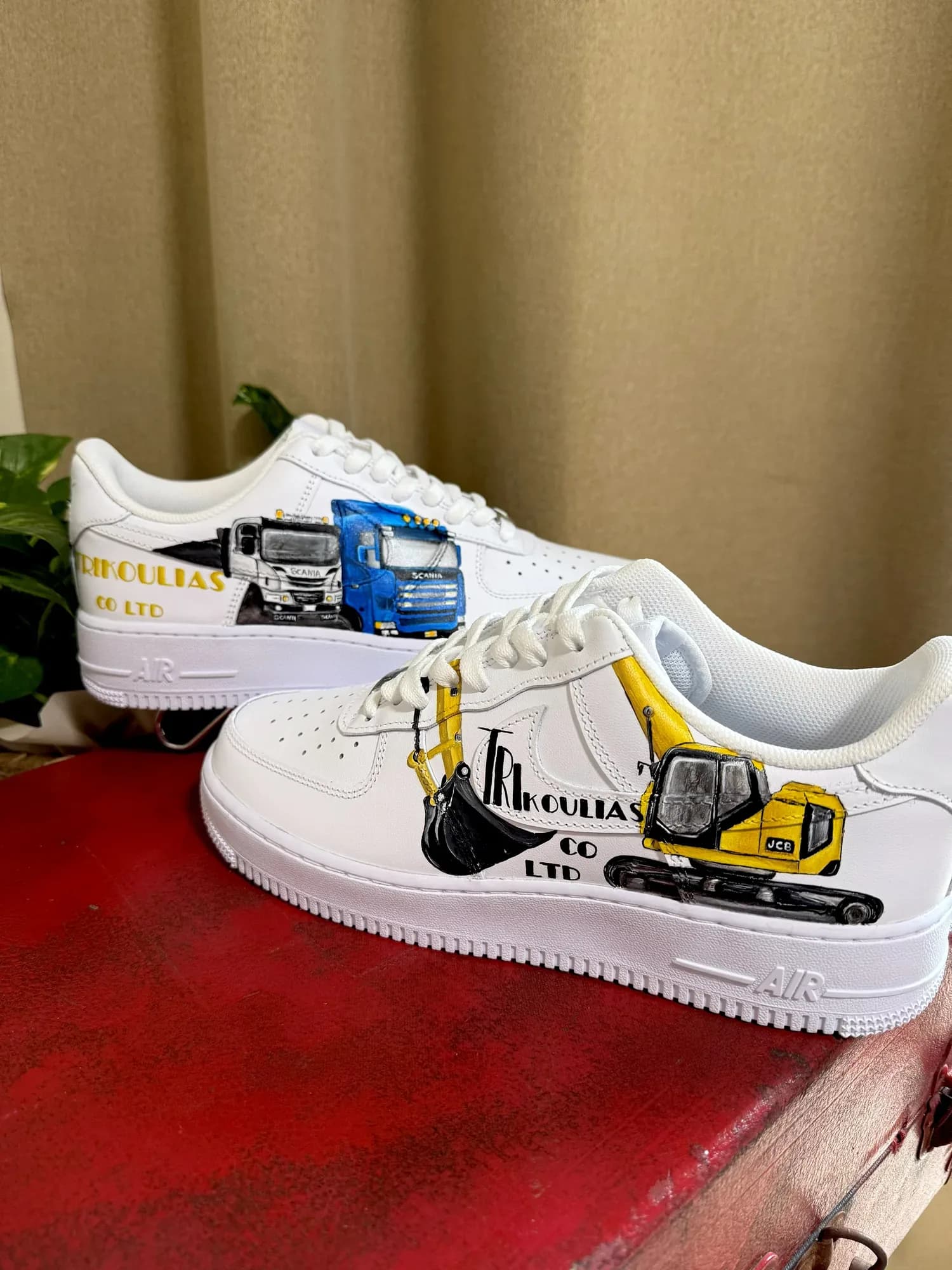 White sneakers hand-painted with a truck and an excavator