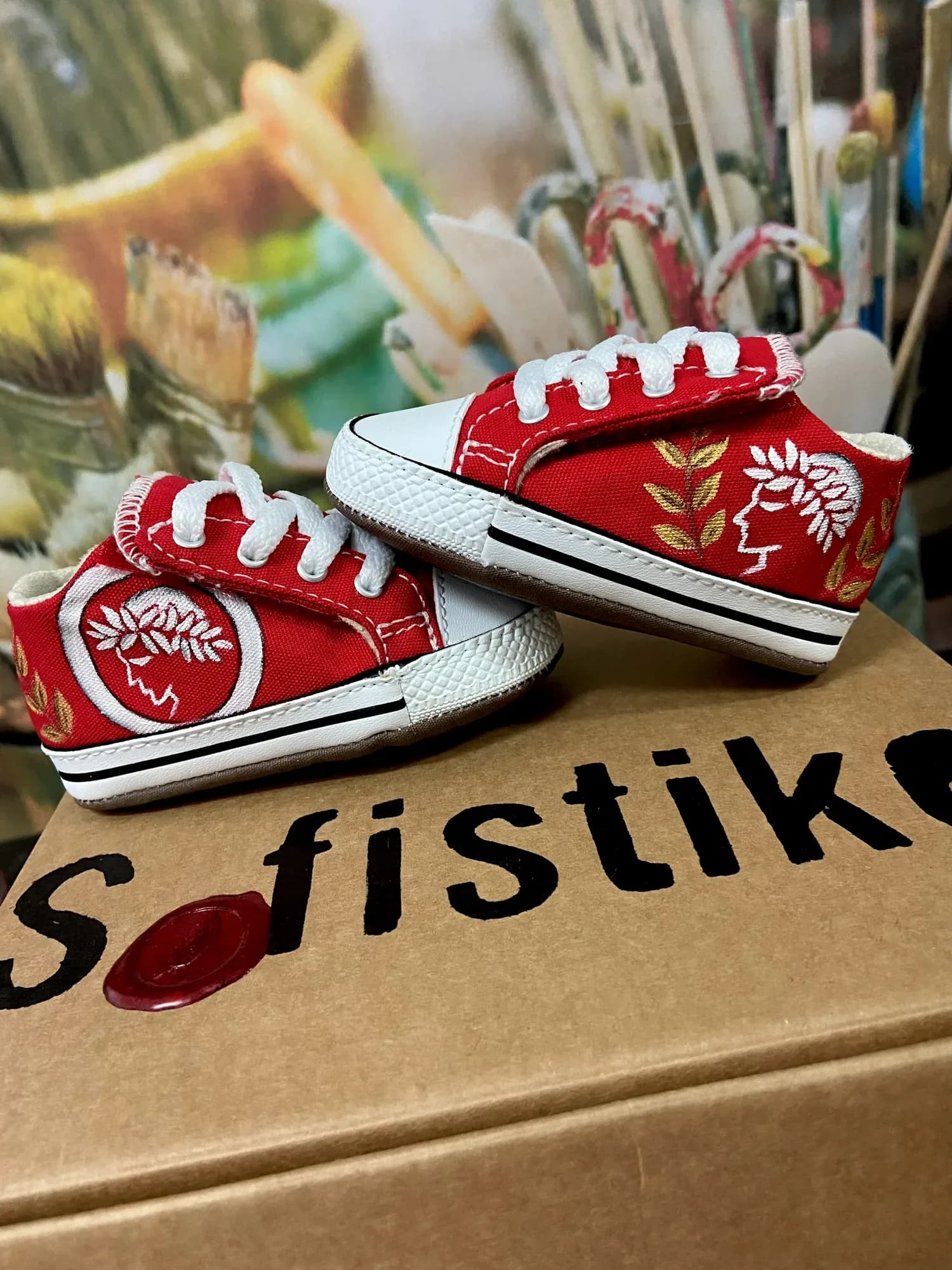Red baby shoes hand-painted with the Olympiacos badge