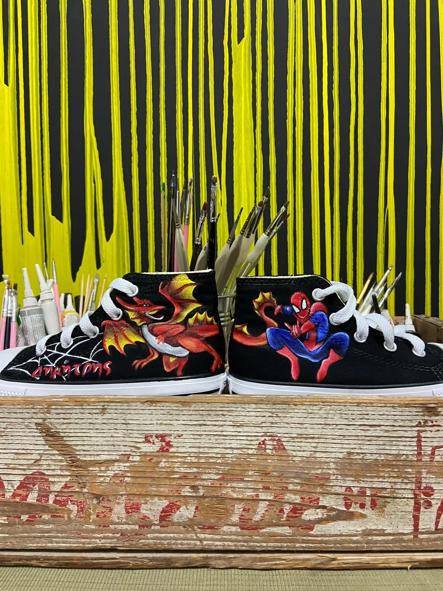 Black high-tops hand-painted with Spider-Man and a red fire dragon