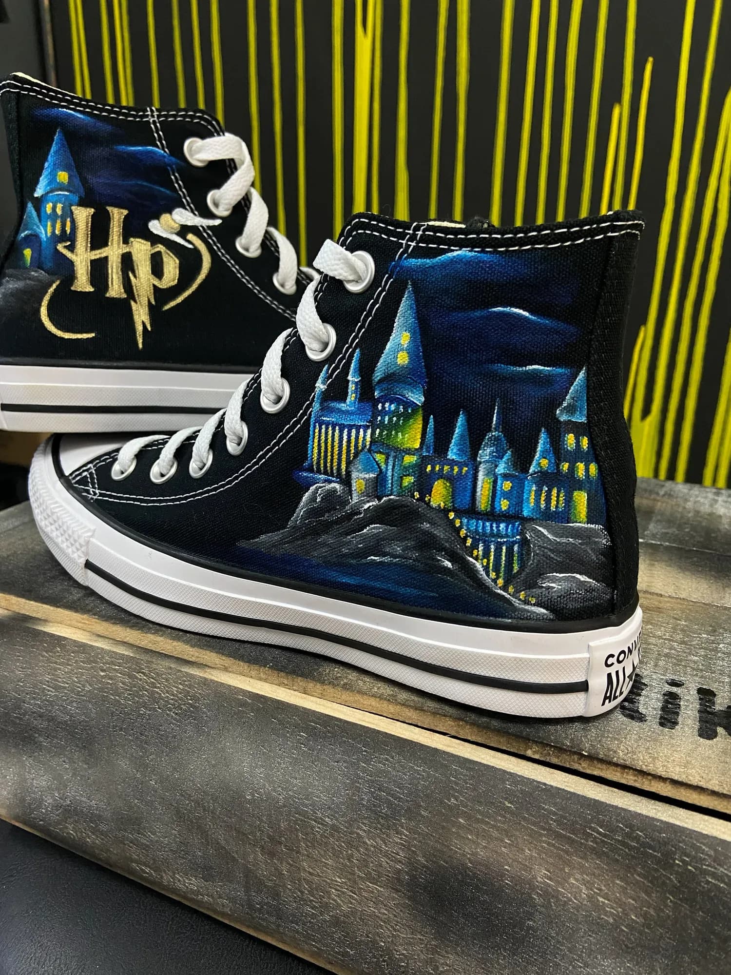 Black high-tops hand-painted with Hogwarts castle and the Harry Potter logo