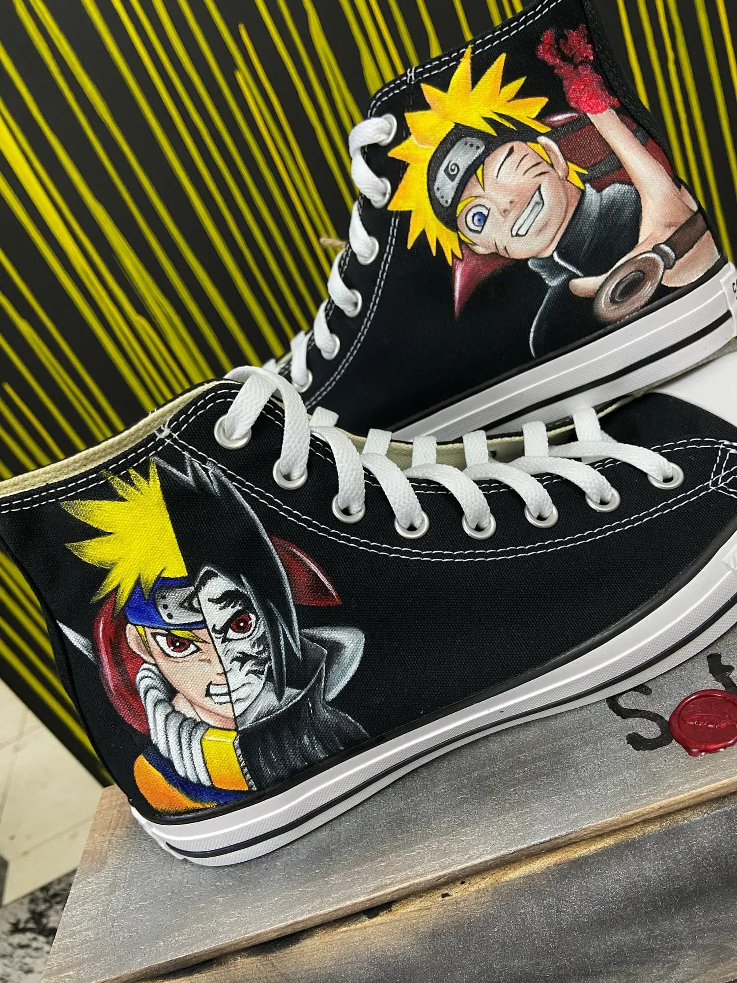 Black high-tops hand-painted with the anime hero Naruto in a two-sided design