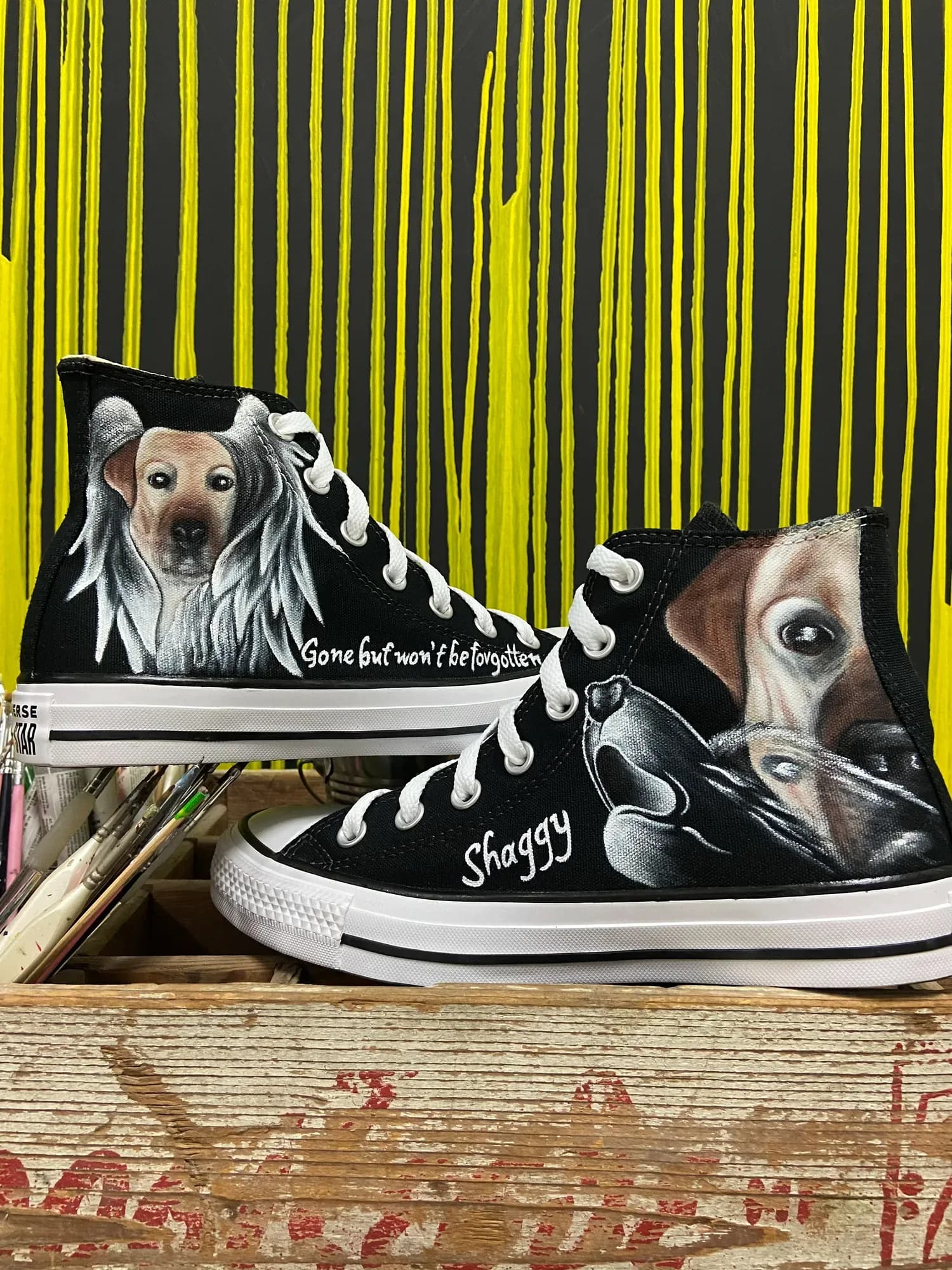 Black high-tops hand-painted with portraits of dogs