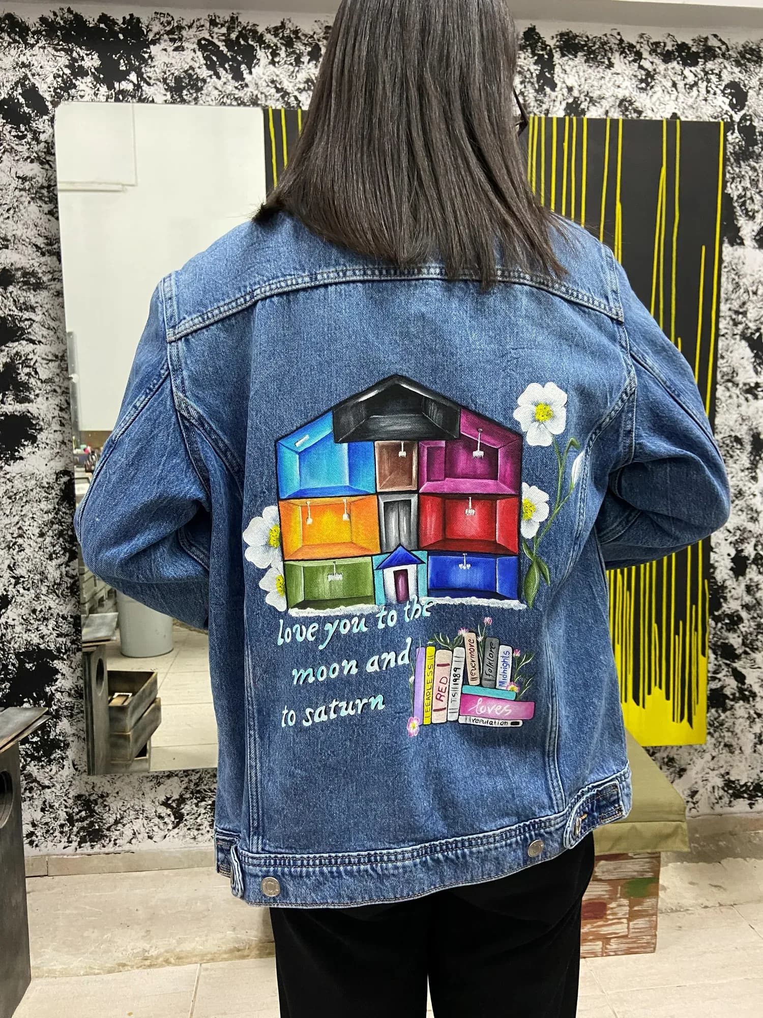 Denim jacket hand-painted on the back with a colourful house and a love quote