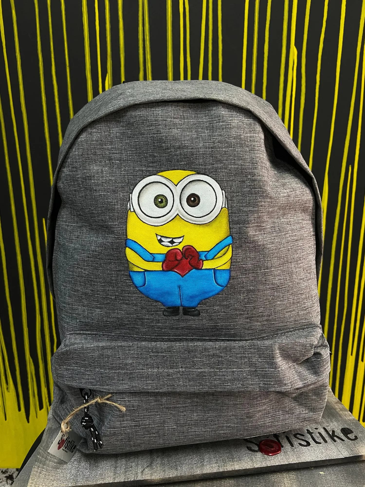 Grey backpack hand-painted with a Minion
