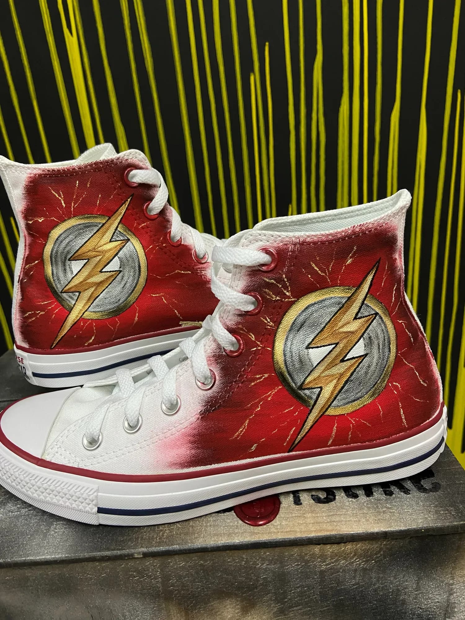 Red high-tops hand-painted with the Flash lightning bolt