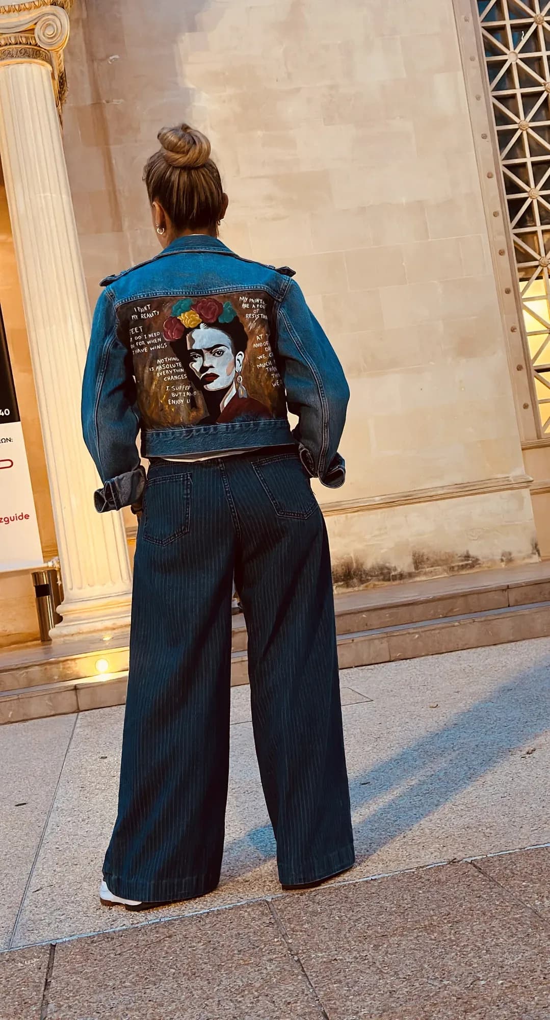 Denim jacket hand-painted on the back with a portrait of a woman with flowers in her hair and handwritten text