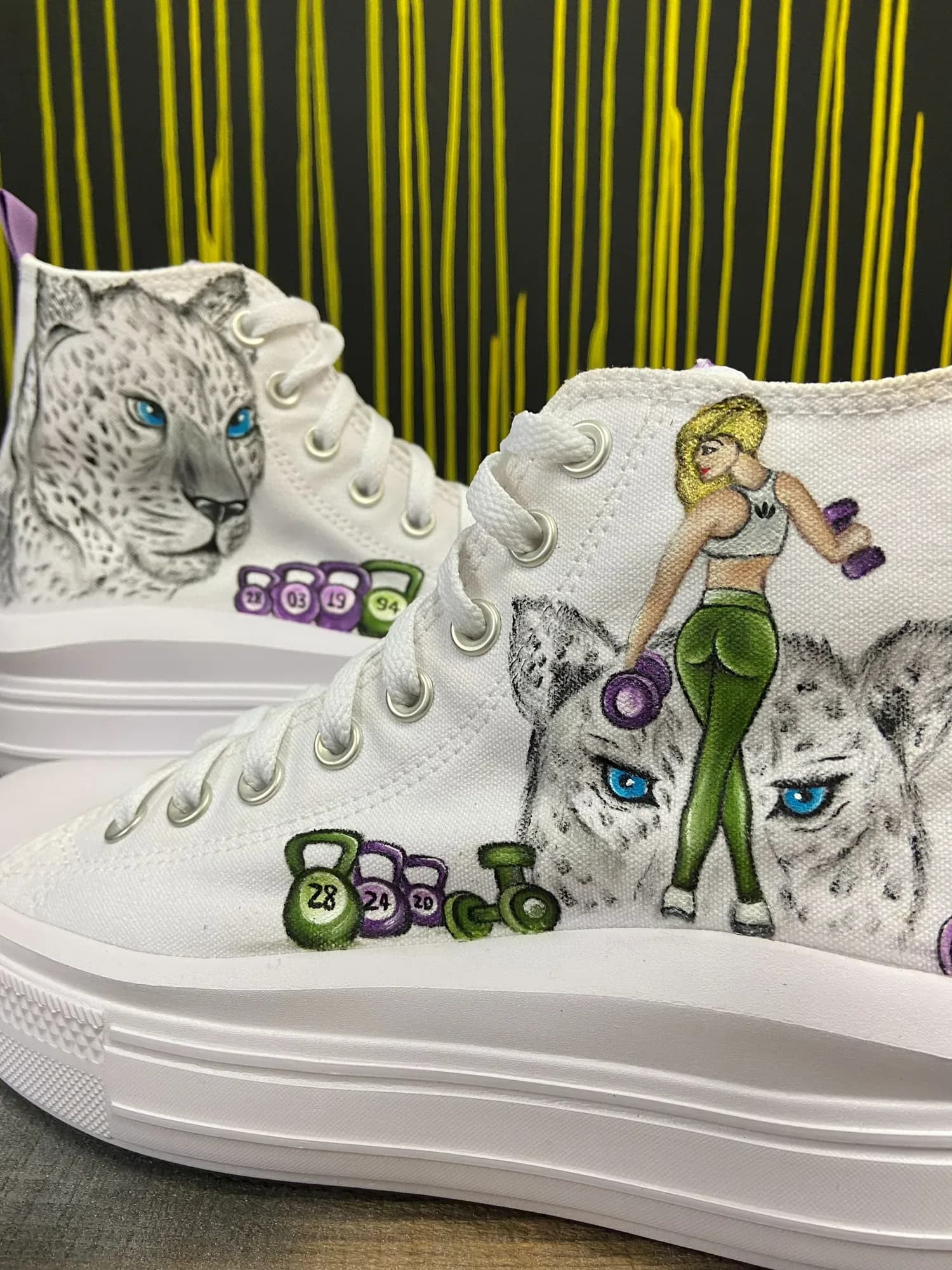 White platform sneakers hand-painted with snow leopards and fitness designs