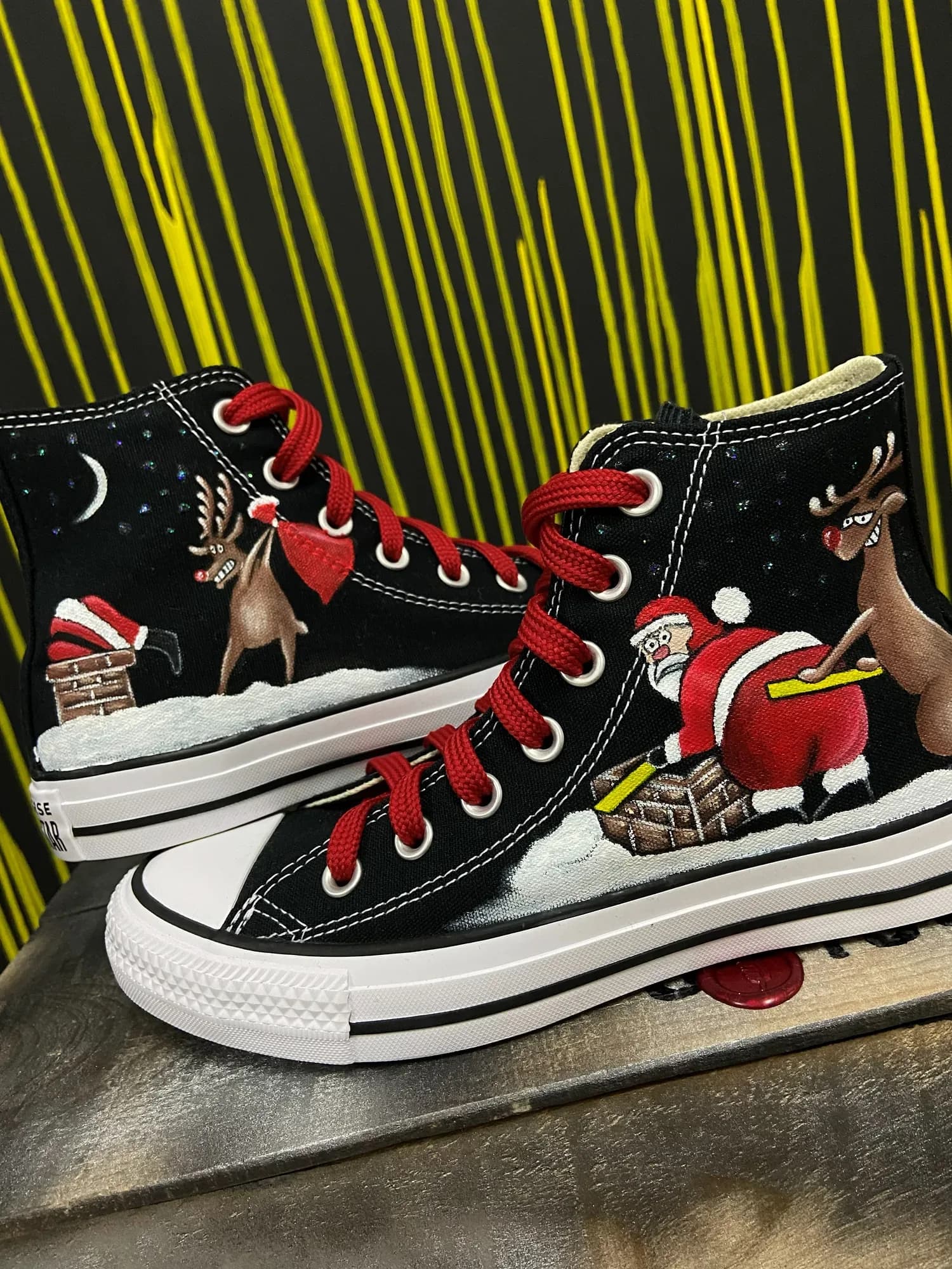 Black high-tops hand-painted with Santa and reindeer in the snow