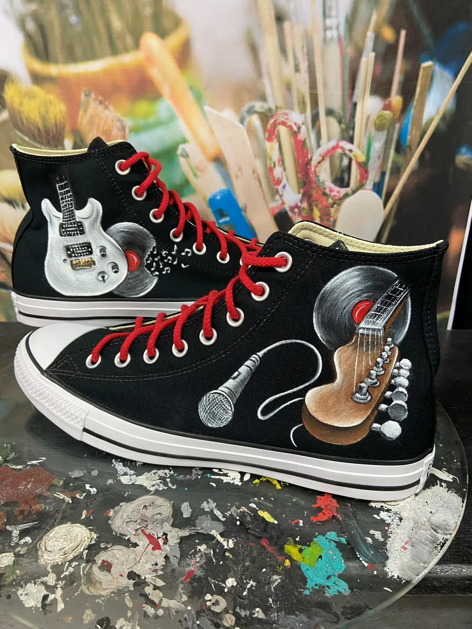 Black platform high-tops hand-painted with a guitar, microphone and vinyl record